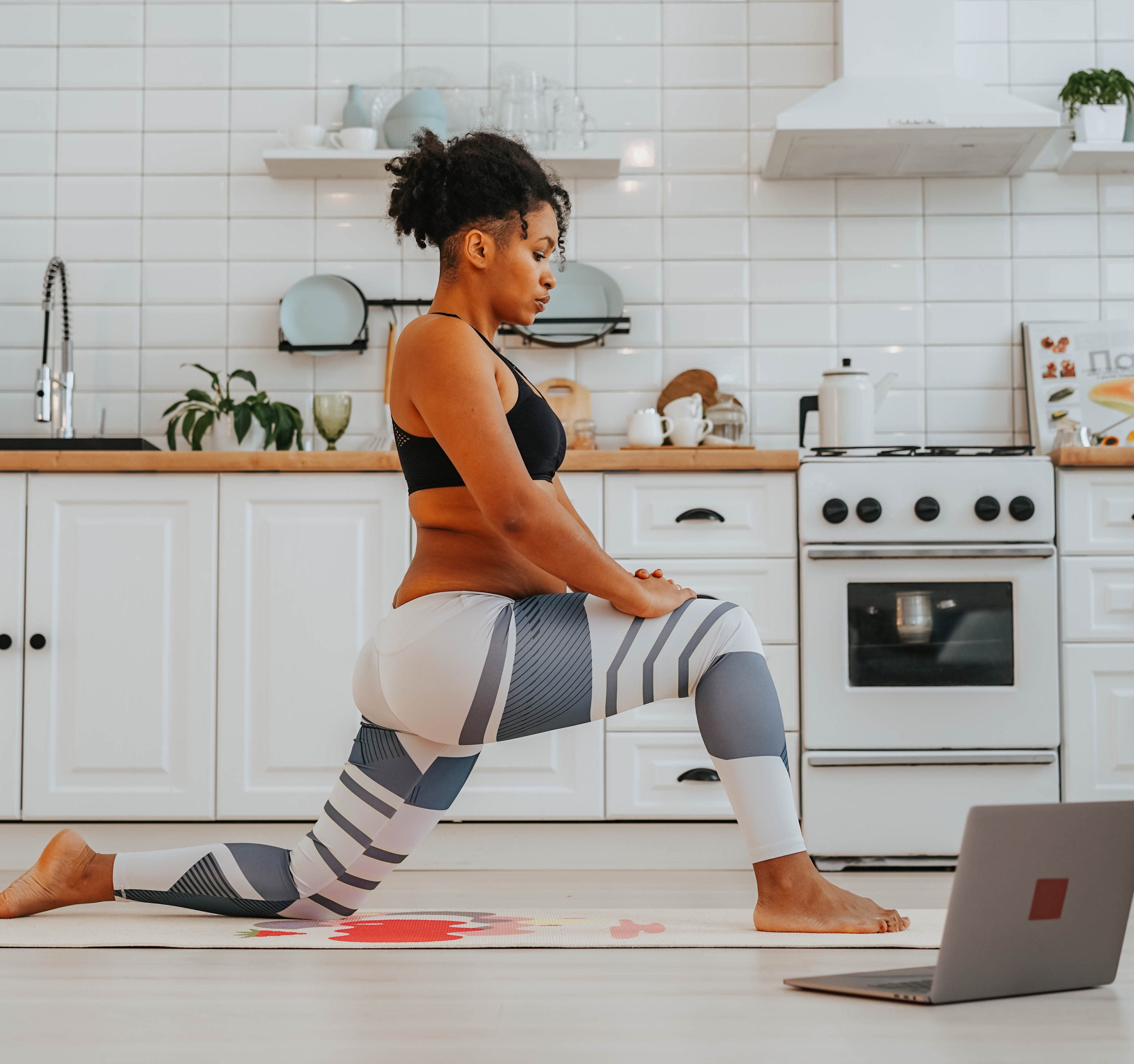 Woman exercising at laptop